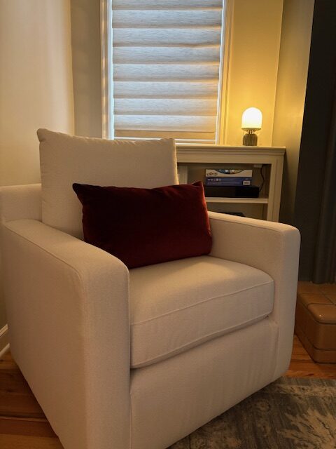 Cozy armchair in a softly lit room representing clarity, focus, and a calm space to reflect on what matters most